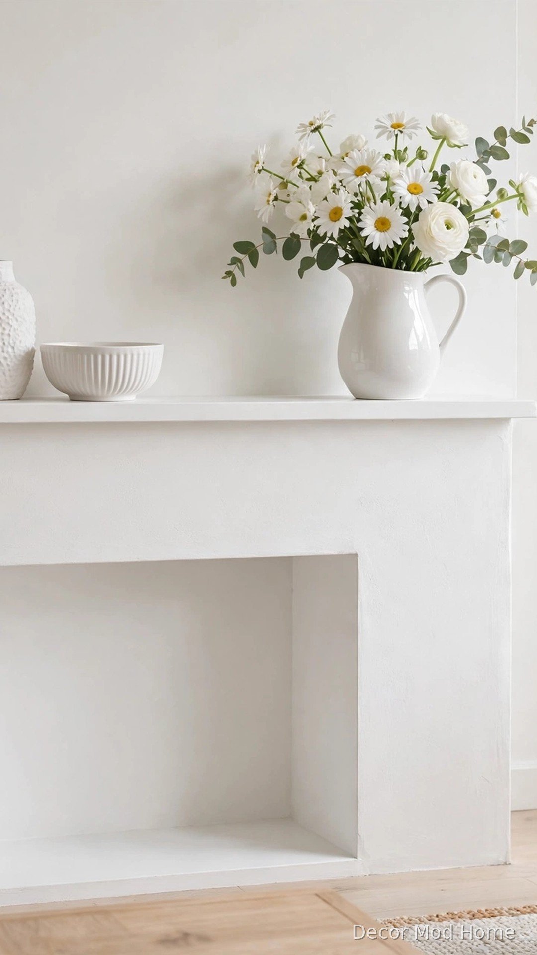 Minimal white-on-white spring mantel with textured ceramics and white blooms