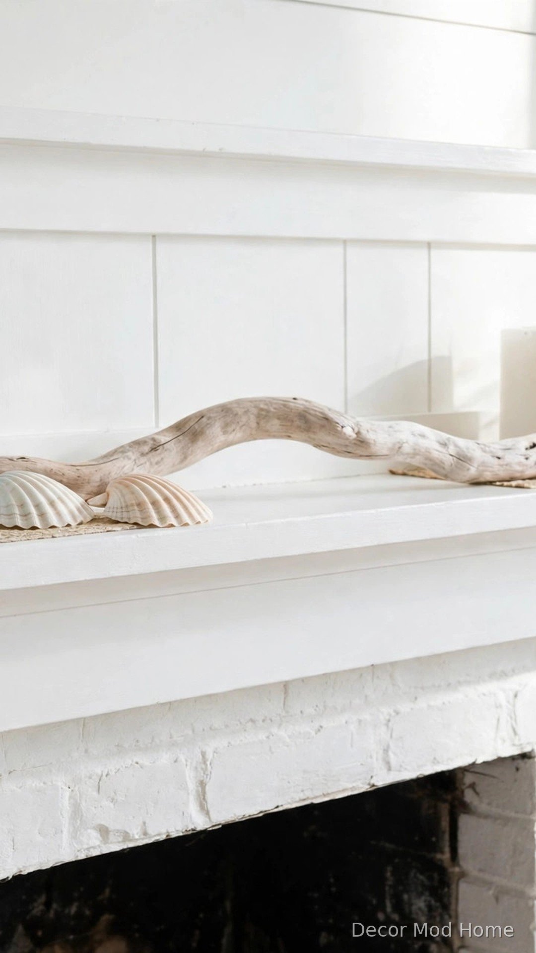 Driftwood and seashells styled as coastal spring decor on a white mantel