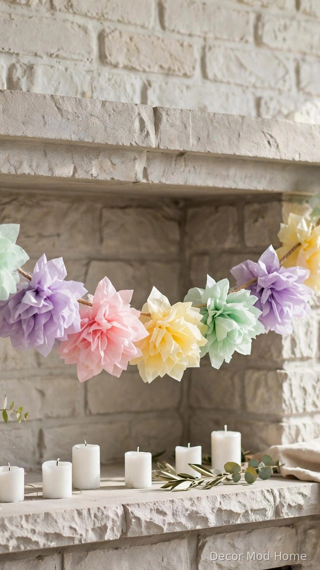 Handmade pastel paper flower garland draped across a spring mantel