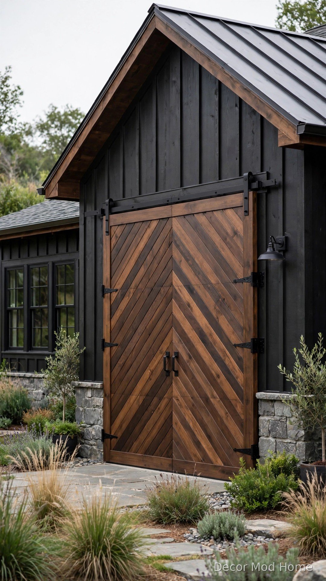Chevron pattern barn style garage door in deep walnut stain with matte black hardware
