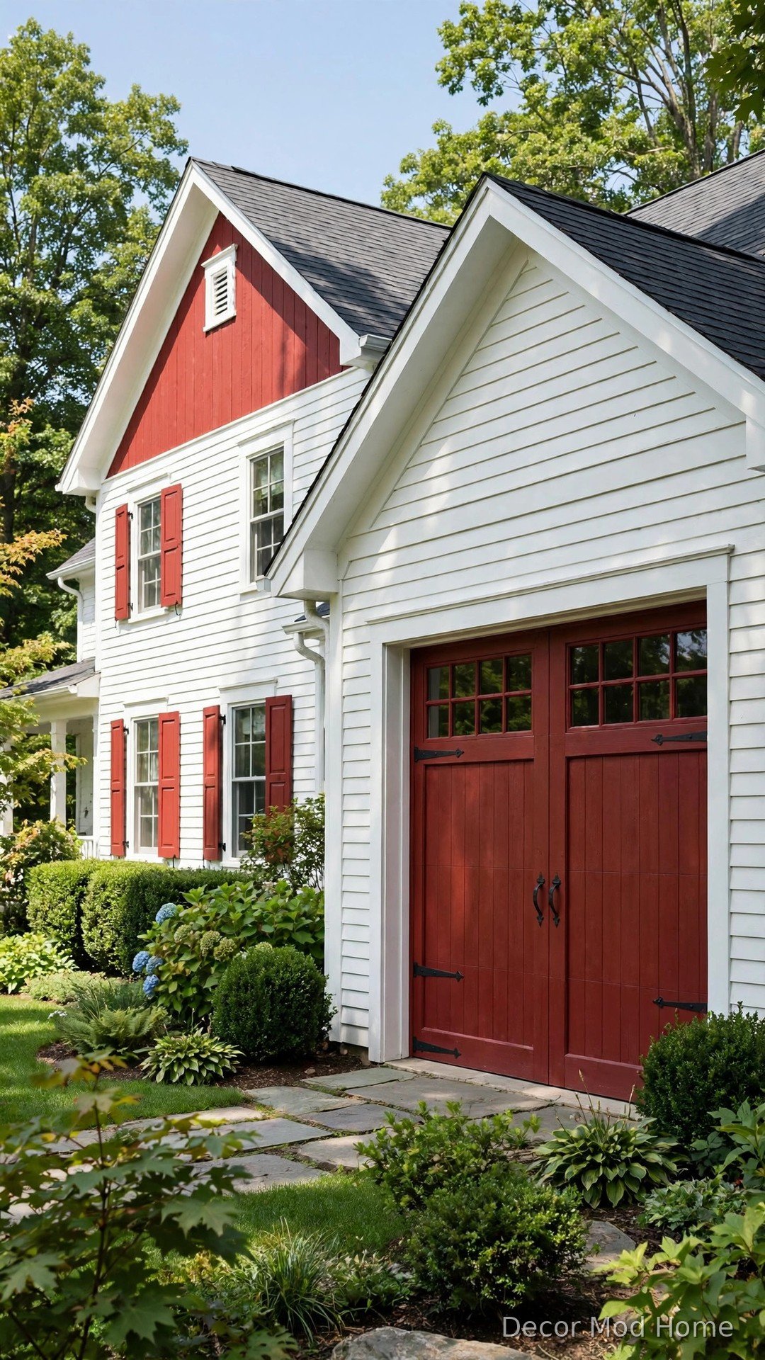 Classic barn red garage door with white trim and black iron hardware